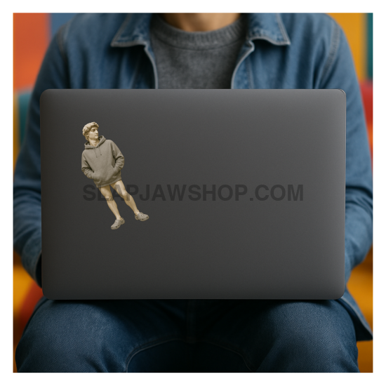 Person sitting with a laptop featuring a sticker of a person in a suit.