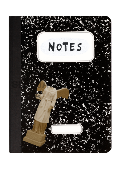 Small black and white notebook with a figurine on top