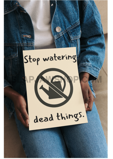 Person holding a sign with humorous message about watering dead things