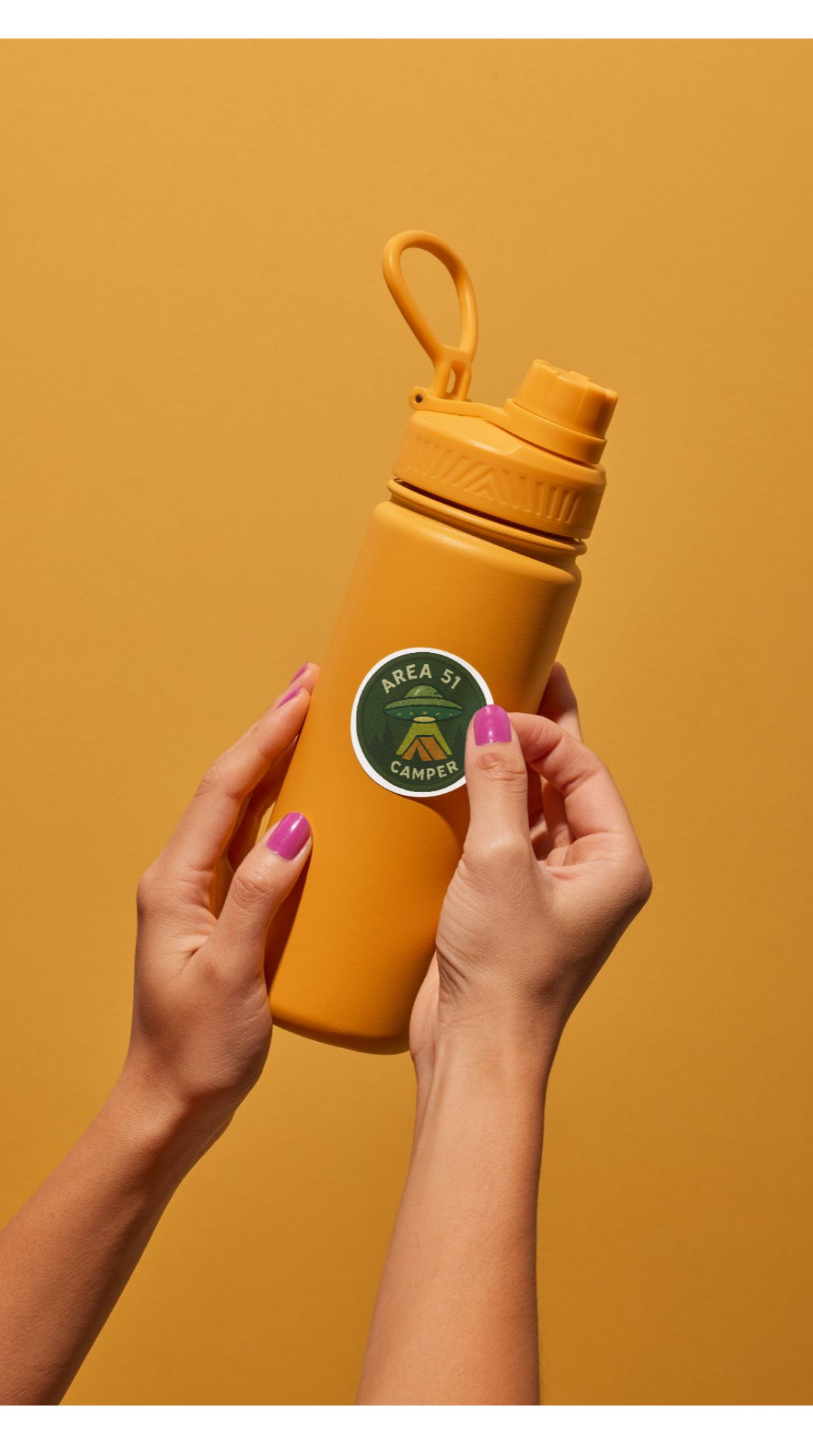Yellow water bottle held by hands against a mustard yellow background