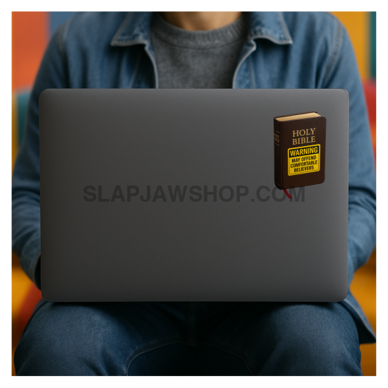 Person sitting with a laptop on their lap, wearing a blue shirt and dark pants.