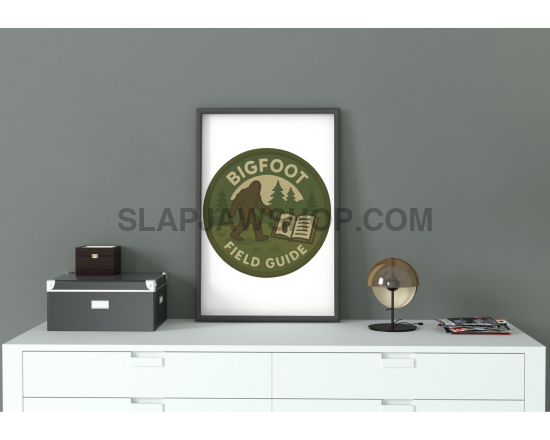 Framed poster titled 'Bigfoot Field Guide' on a white shelf against a gray wall.