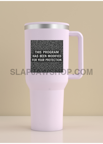 White travel mug with a black label on a beige background