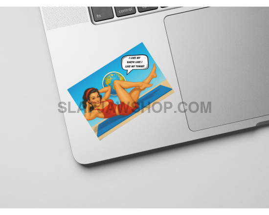 Laptop with a retro-style sticker of a woman in a bikini on a white surface