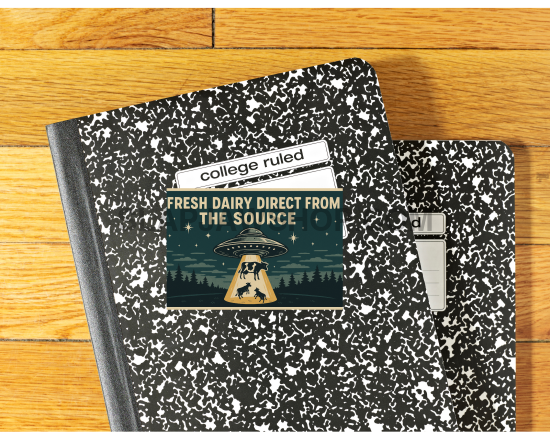 Two black and white notebooks on a wooden surface with visible text.