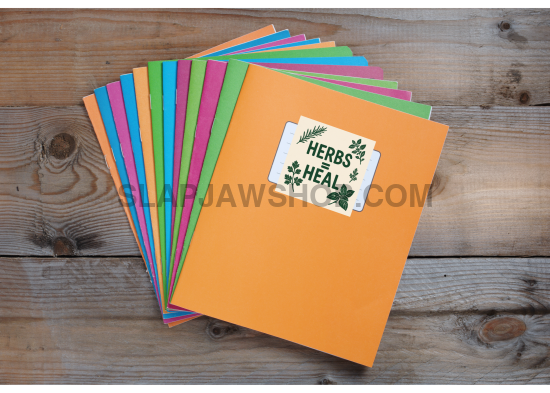 Colorful books with a 'Herbs Heal' label on a wooden surface