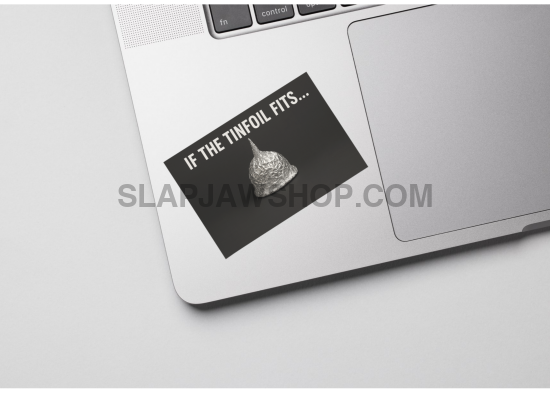 Laptop with a sticker on the palm rest area featuring text and an image of a skull.