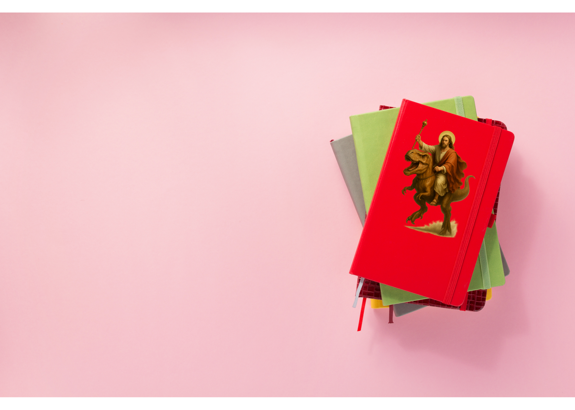 Stack of colorful books with a red one featuring a dragon design on a pink background