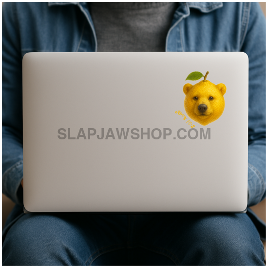 Person holding a laptop with a yellow bear sticker on the back
