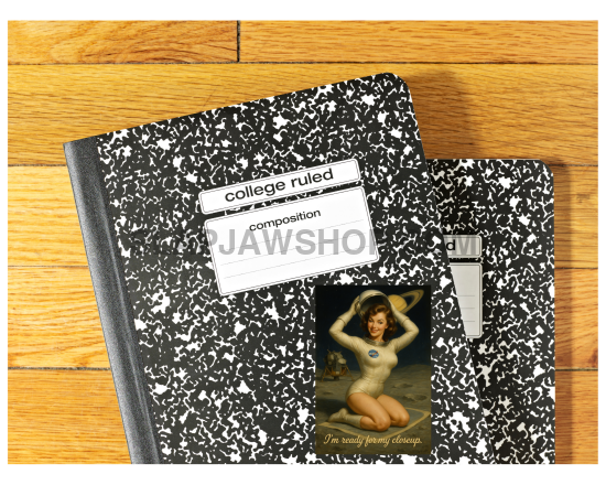 Two black and white composition notebooks on a wooden surface