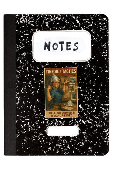 Black notebook with white speckles and a label on a white background