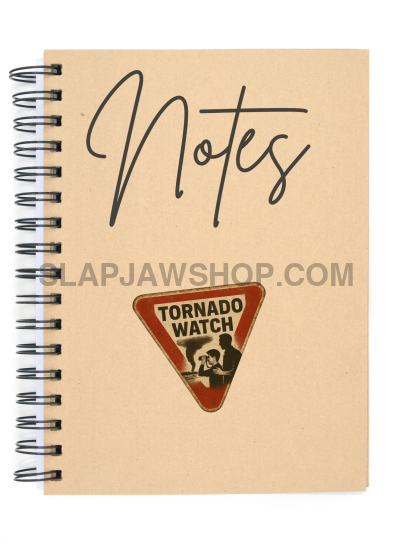 Framed poster with 'Tornado Watch' warning sign on a gray wall with a black lamp.