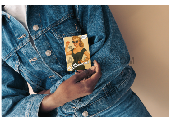 Person wearing a denim jacket holding a product with a label.