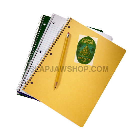 Yellow notebook with a green sticker and a pencil on a white background