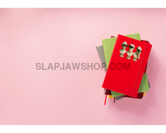Stack of colorful notebooks on a pink background