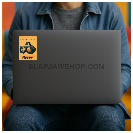 Person holding a laptop with a sticker on the cover